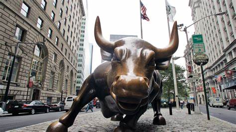 Wall Street's iconic charging bull statue vandalized by climate activists wielding neon green paint