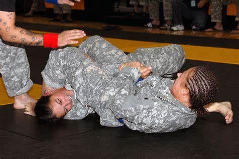 Female fights male opponent in Army Combatives match