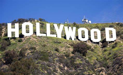 Person waves cryptocurrency flag atop Hollywood sign - KTLA Los Angeles