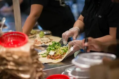 Chipotle wants its workers to smile for customers