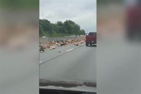 Thousands of Hot dogs spill across busy highway