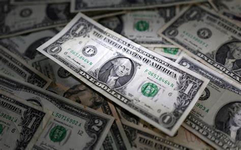 US dollar rises, British pound falls as markets weigh trade deals, Fed rate cut