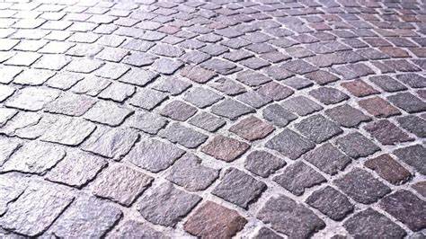 Designed grey granite pavement on local road in old town
